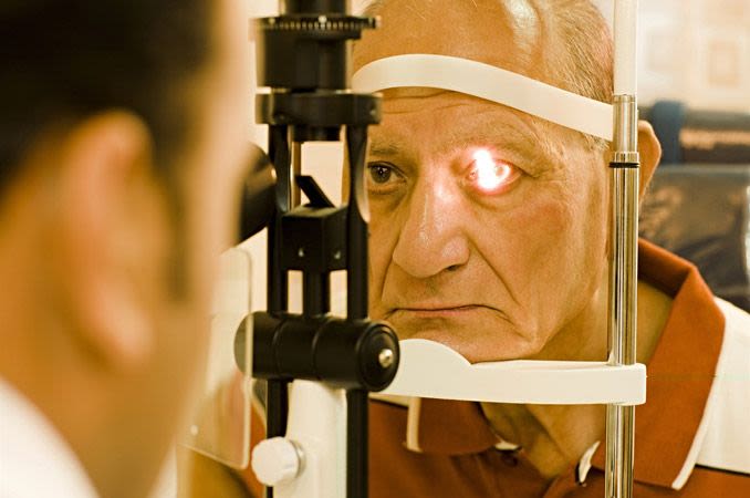 An older man getting an eye exam.
